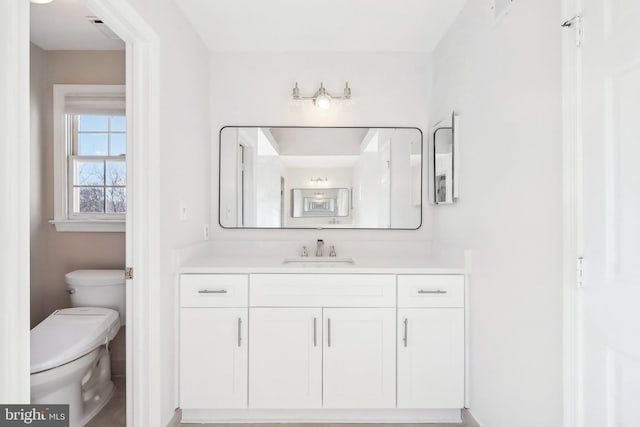 bathroom featuring vanity and toilet