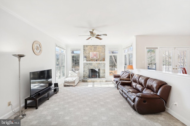 living room with ceiling fan, a healthy amount of sunlight, crown molding, and light carpet