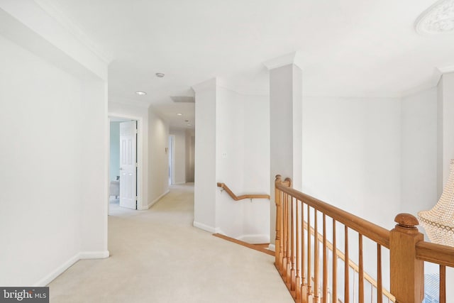 hall with light carpet and ornamental molding