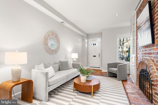 living room featuring a brick fireplace