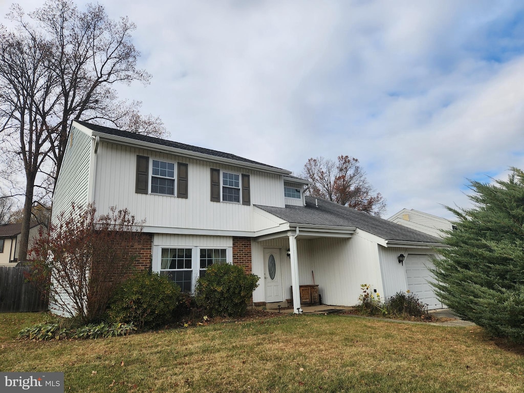 front facade with a front yard and a garage