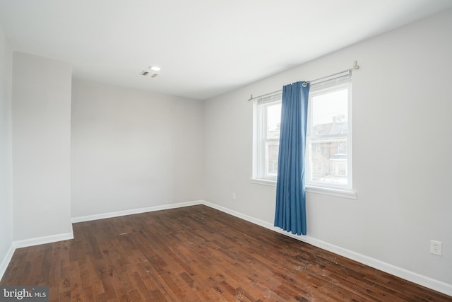 spare room featuring dark hardwood / wood-style floors