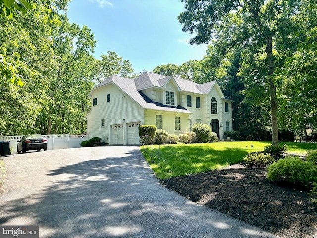 view of front facade with a front lawn and a garage