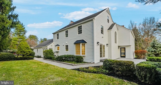 189 Constitution Dr, Princeton, NJ 08540 - view of home's exterior featuring a chimney, a yard, and a patio area