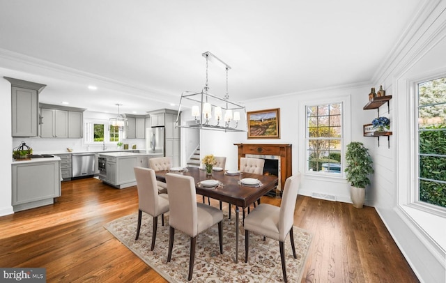 189 Constitution Dr, Princeton, NJ 08540 - dining area featuring crown molding, stairway, dark wood-type flooring, a chandelier, and recessed lighting