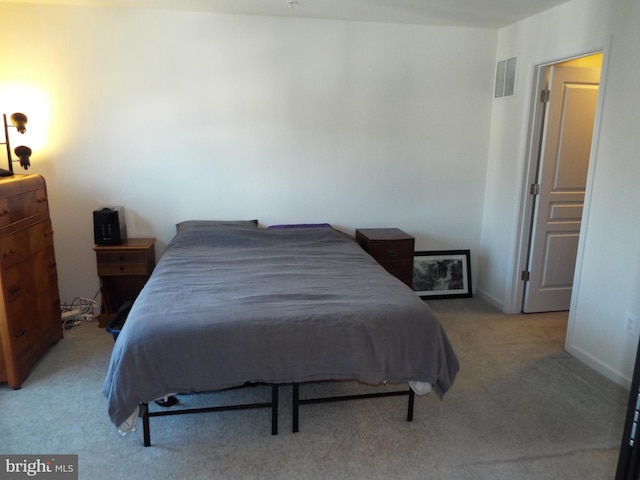 bedroom featuring light colored carpet