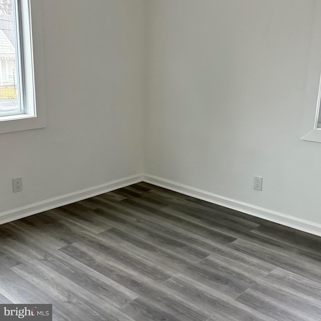 spare room with dark hardwood / wood-style flooring