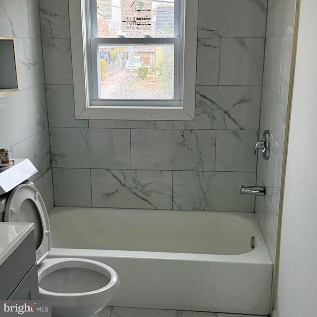 full bathroom with vanity, toilet, and tiled shower / bath