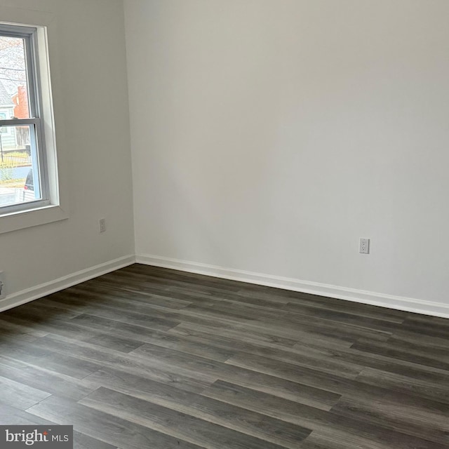 unfurnished room with dark hardwood / wood-style floors