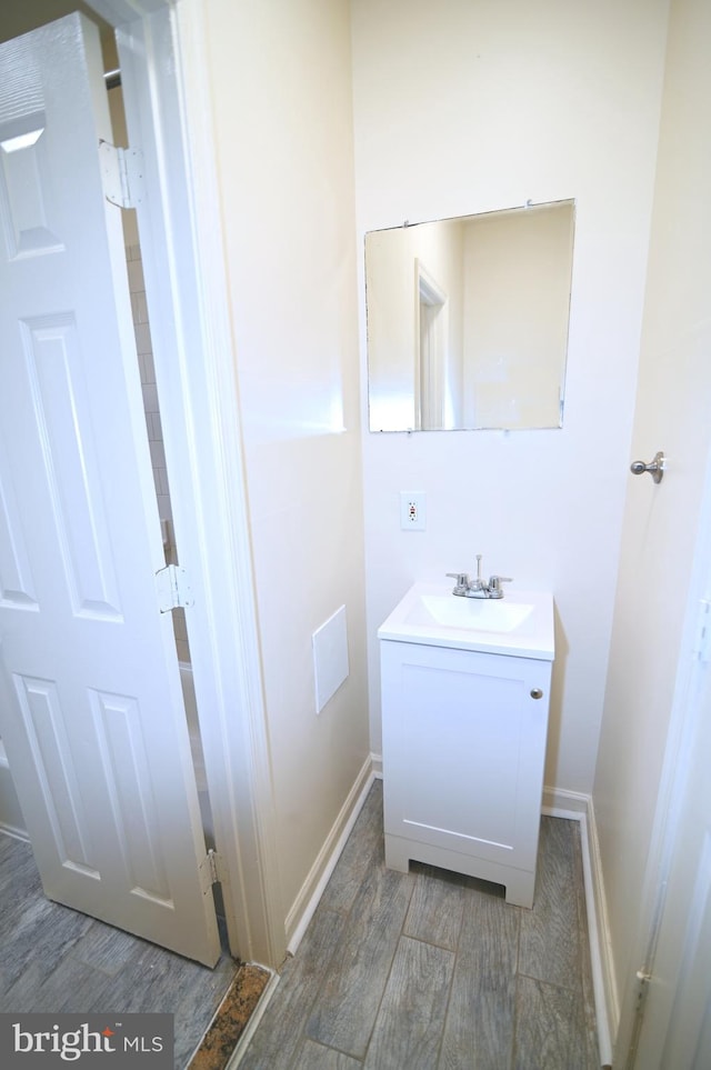 bathroom with hardwood / wood-style floors and vanity