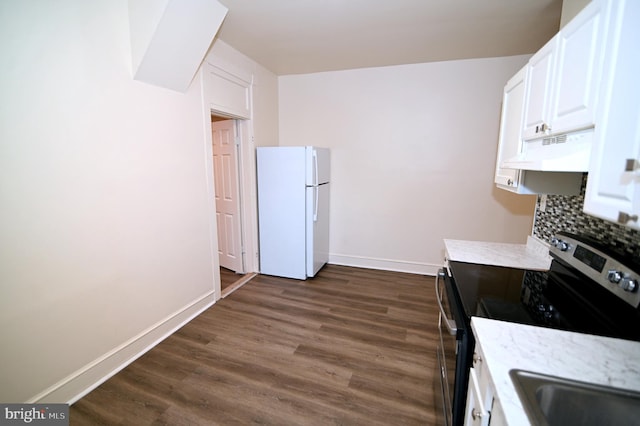 kitchen with white cabinetry, white fridge, and stainless steel range with electric stovetop