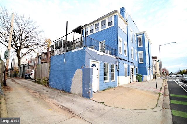 view of side of home with a balcony