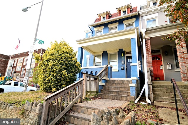 townhome / multi-family property featuring a porch