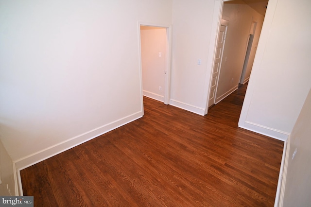 empty room with dark hardwood / wood-style floors