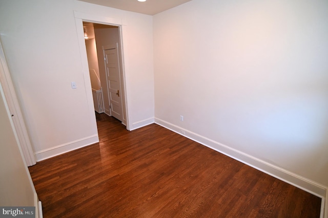 unfurnished room featuring dark hardwood / wood-style flooring