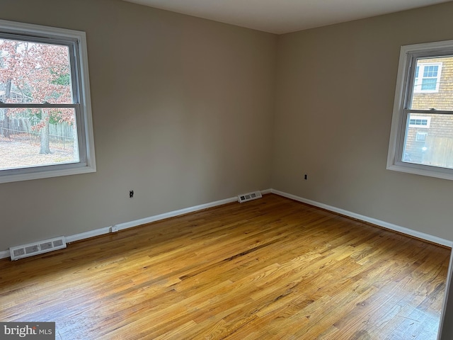 spare room featuring light hardwood / wood-style floors