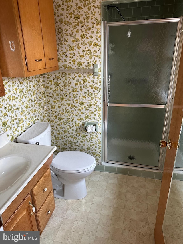 bathroom with vanity, toilet, and walk in shower