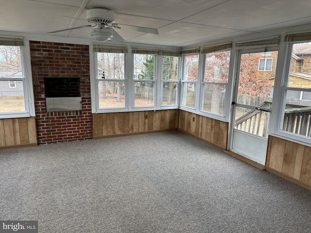 unfurnished sunroom with ceiling fan and a healthy amount of sunlight