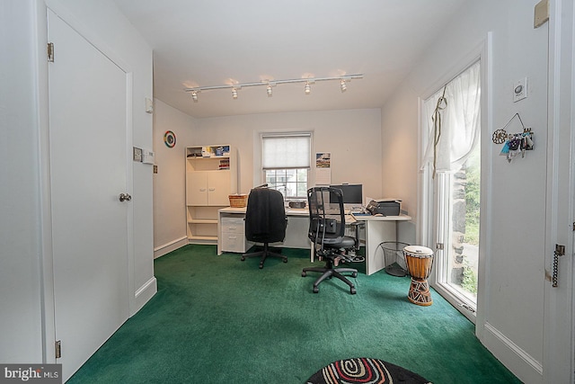 office with baseboards, dark colored carpet, and track lighting