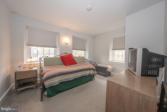 bedroom featuring carpet floors and baseboards