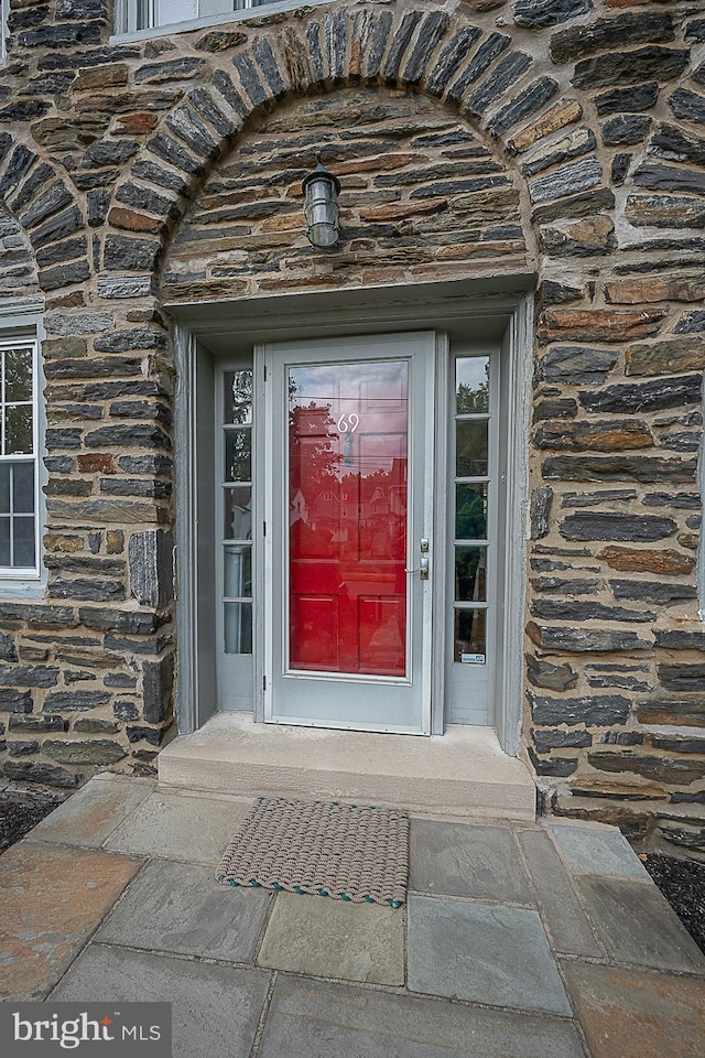 view of exterior entry featuring stone siding