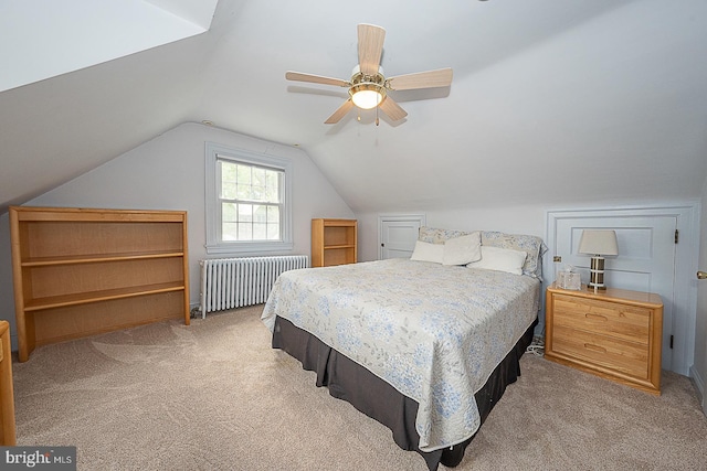 bedroom featuring light carpet, ceiling fan, vaulted ceiling, and radiator