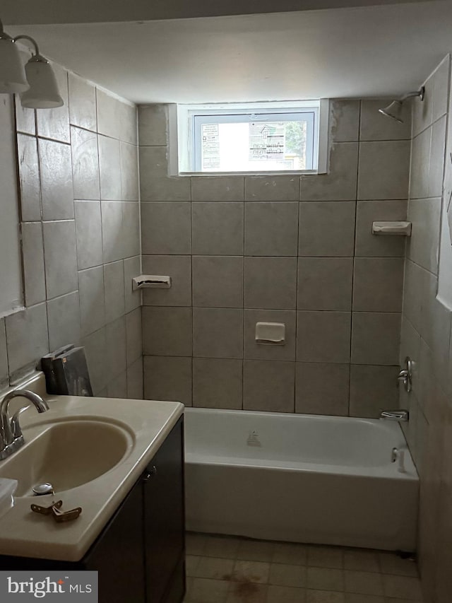 bathroom with vanity, tiled shower / bath combo, and tile patterned floors