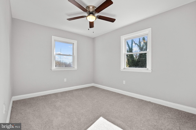 spare room featuring carpet flooring, ceiling fan, and a healthy amount of sunlight