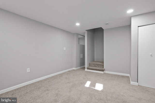 basement featuring light carpet