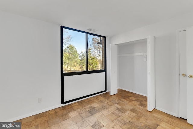 unfurnished bedroom with light parquet flooring