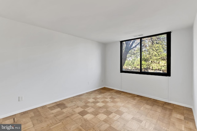 spare room with light parquet flooring