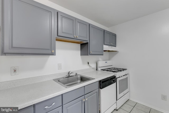 kitchen with gray cabinets, sink, light tile patterned flooring, and white appliances