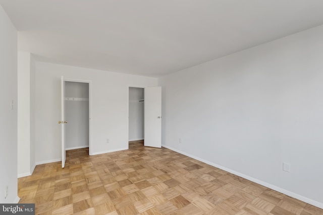 unfurnished bedroom featuring light parquet flooring