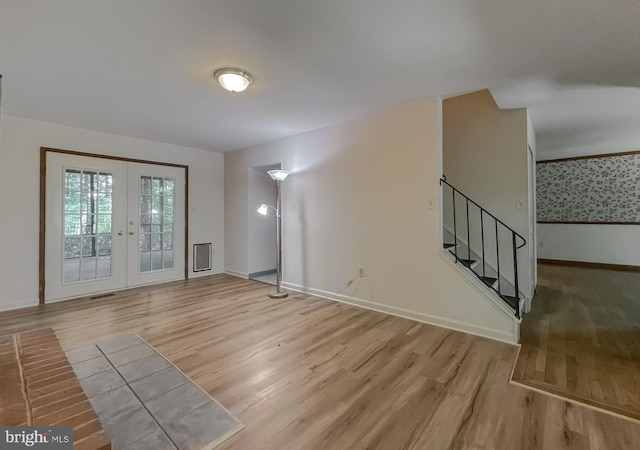 interior space with light wood-type flooring and french doors