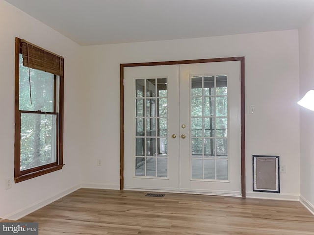 entryway featuring light hardwood / wood-style flooring and french doors