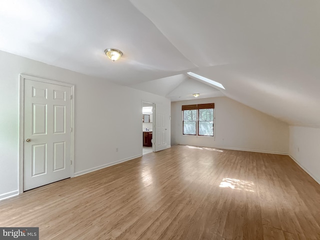 bonus room featuring light hardwood / wood-style floors and vaulted ceiling