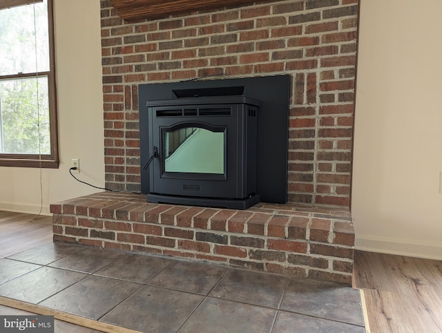 room details featuring hardwood / wood-style flooring and a wood stove