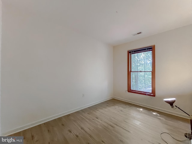 spare room with light hardwood / wood-style floors