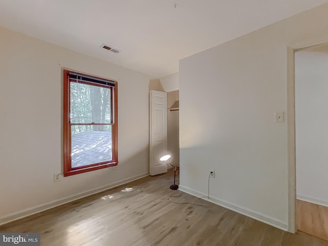 unfurnished room with light hardwood / wood-style flooring