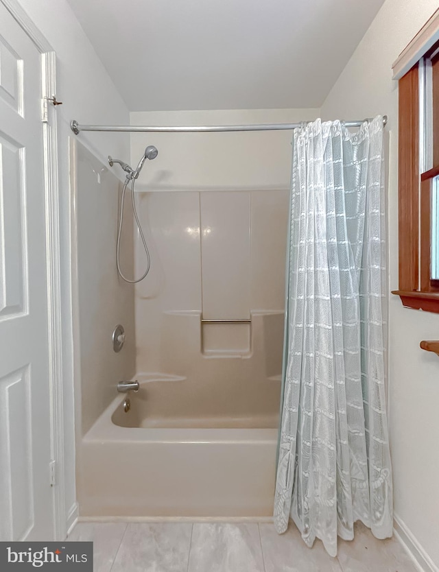 bathroom with tile patterned flooring and shower / bath combo with shower curtain