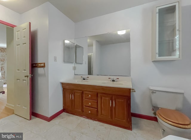 bathroom featuring toilet and vanity