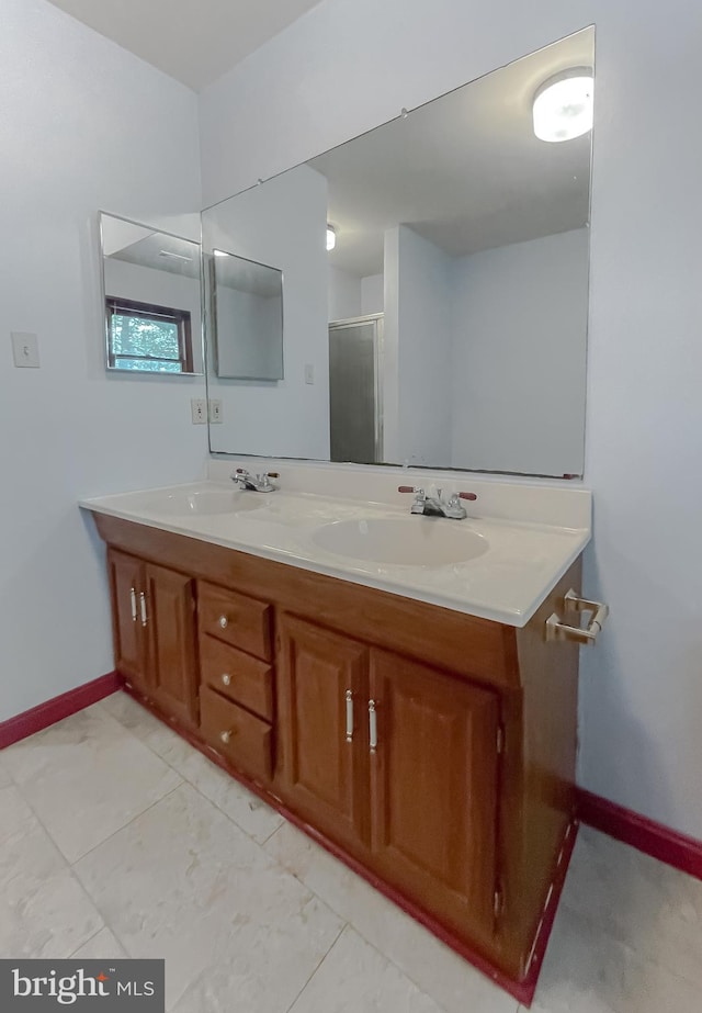 bathroom with walk in shower and vanity