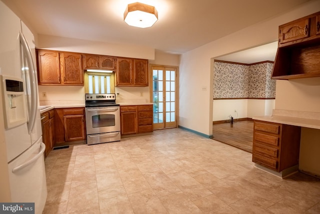 kitchen featuring french doors, white fridge with ice dispenser, and stainless steel electric stove