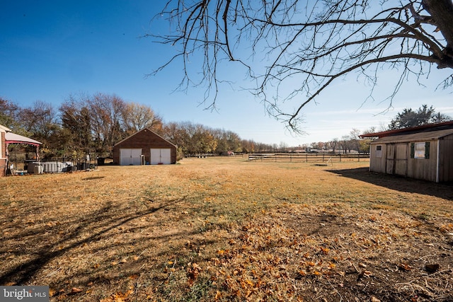 view of yard with an outbuilding and a rural view