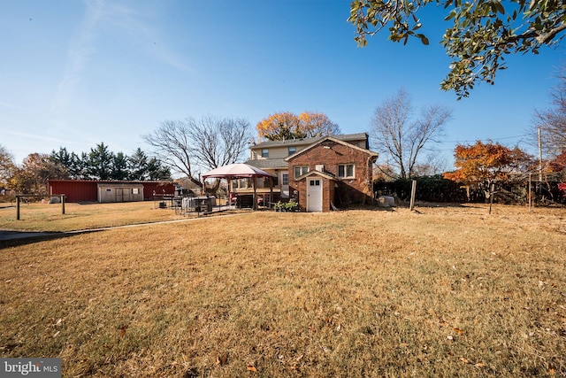 exterior space with a gazebo, a storage shed, and a lawn