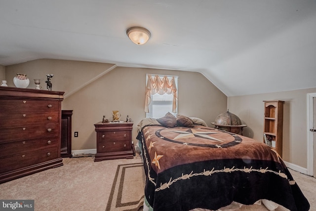 bedroom featuring light carpet and vaulted ceiling