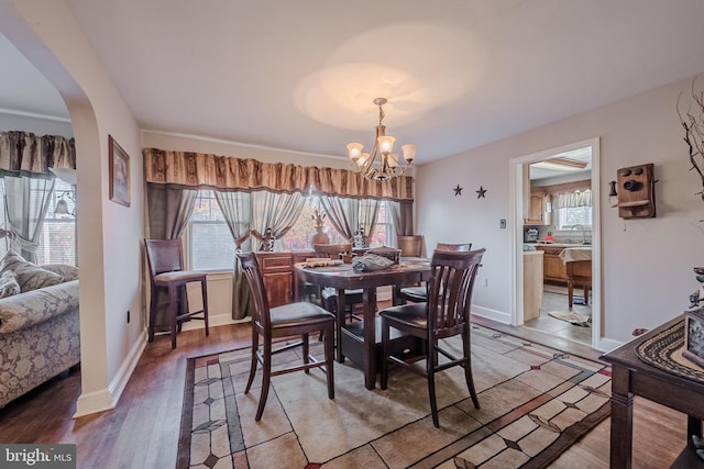 dining area featuring hardwood / wood-style floors and a chandelier