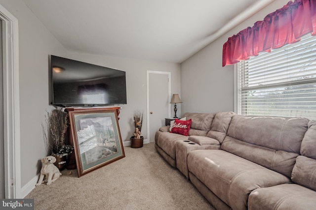 carpeted living room featuring lofted ceiling