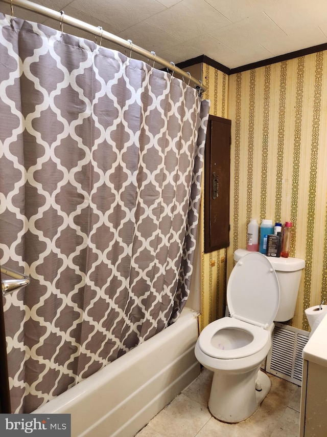 bathroom with shower / tub combo with curtain, tile patterned flooring, and toilet