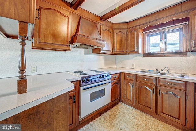 kitchen with custom exhaust hood, white electric range oven, sink, pendant lighting, and beamed ceiling